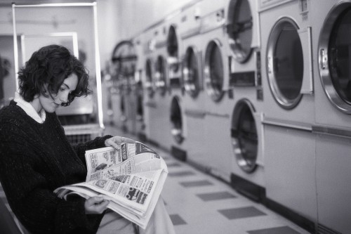 Woman Reading in Laundromat ca. 2000